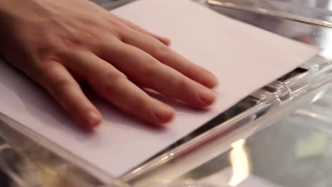 A-hand-casts-a-vote-in-a-ballot-box-during-the-elections-in-Athens,-Greece