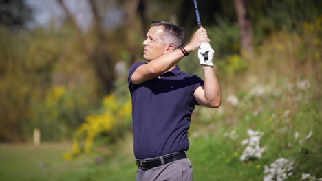 Cinematic-shot-of-a-golfer-swinging-in-slow-motion-on-a-sunny-day