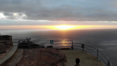 Man-Walking-into-Sunset-in-Chapman's-Peak,-Cape-Town
