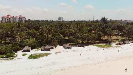 Playa-De-Mombasa-Durante-Una-Puesta-De-Sol-Nublada,-Con-Resorts-Al-Fondo