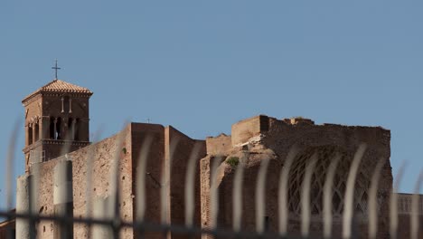 still-far-shot-for-ancient-old-church-building-in-the-roman-forum-area-with-blurred-foreground-fences