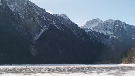 Lago-del-Predil,-Tarvisio---Italy-a-frozen-alpine-lake-in-a-snow-covered-winter-fairytale-mountain-landscape