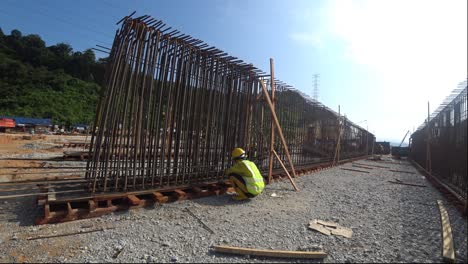 Construction-workers-fabricating-steel-reinforcement-bar-to-form-reinforcement-concrete-at-the-construction-site