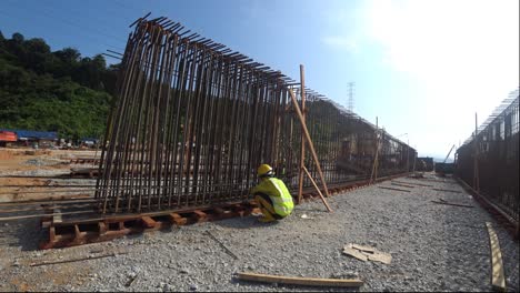 Bauarbeiter-Stellen-Auf-Der-Baustelle-Stahlbewehrungsstäbe-Her,-Um-Bewehrungsbeton-Zu-Formen