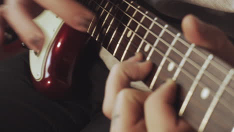 Hands-with-a-shabby-black-nail-polish-playing-the-guitar