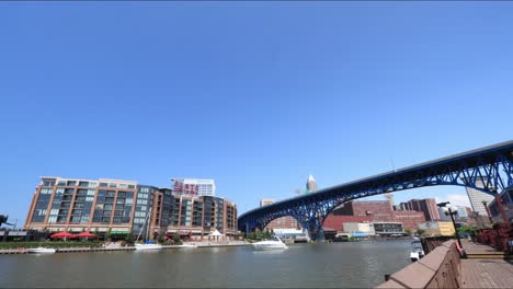 Boats,-kayaks,-jet-skis-all-coast-by-in-a-day-time-lapse-on-the-Cuyahoga-River-in-Cleveland-Ohio