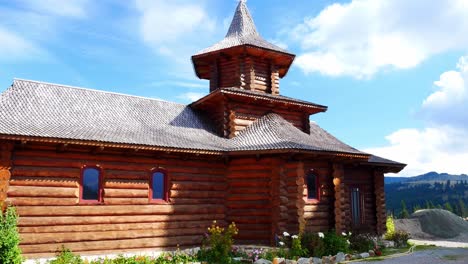 Panning-shot-of-the-old-wooden-church-at-the-Prislop-pass-monastery-on-a-bright-summer-day