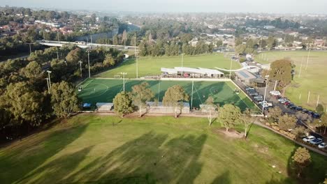 Aerial-drone-footage-flying-down-towards-Elgar-Park-field-hockey-ground-while-a-match-is-being-played