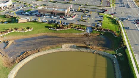 Stormwater-runoff-water-management-at-large-retail-shopping-center,-aerial-tilt-up