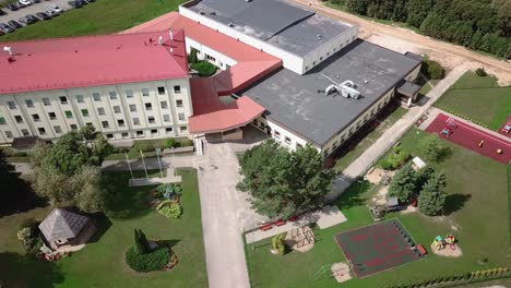 Aerial-view-of-school-building,-with-the-playground-next-to-it---ORBITAL-movement-to-the-RIGHT