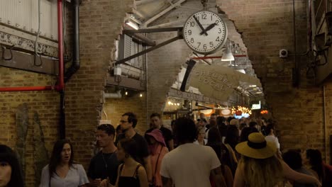 People-walking-on-the-corridor-of-Chelsea-Market,-New-York-City