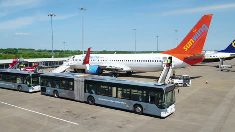 Tracking-shot-of-a-Sunwing-airplane-taxiing-to-its-arrival-terminal-gate