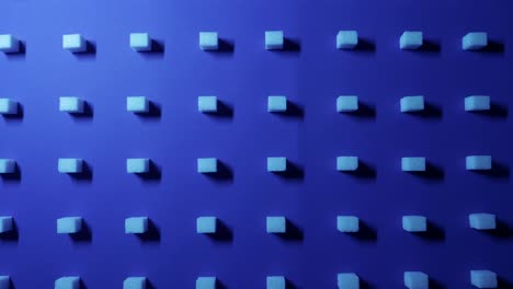 Ein-Zoom-In-Die-Ansicht-Eines-Einzigartigen-Kubischen-4K-Hintergrunds-Mit-Weißen-Zuckerwürfeln,-Die-In-Reihen-Auf-Einem-Dunkelblauen-Hintergrund-Angeordnet-Sind,-3D-Effekt