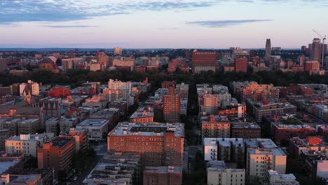 Aerial-footage-over-Harlem,-NYC-at-golden-hour-daybreak