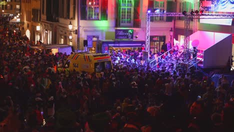 High-angle-shot-showing-crowd-of-people-in-costume-celebrate-carnival-festival-outdoor-during-night