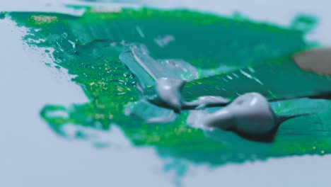 Blue-Green-and-Gray-paint-are-mixed-together-to-make-an-aqua-green-color