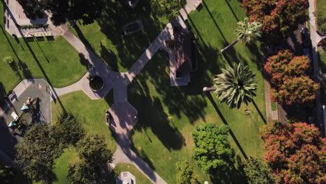 Aerial-overhead-descending-shot-above-the-park,-Central-Park-Historic-District,-Whittier,-California,-United-States