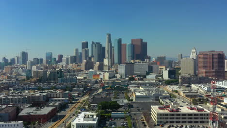 Epic-pullback-drone-shot-of-the-Downtown-Los-Angeles-Skyline-on-a-Clear-Blue-Sky-Sunny-Day,-California,-USA