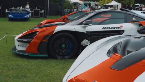 Arc-Shot-of-a-Mclaren-Senna-with-Other-Hypercars-at-Car-Show