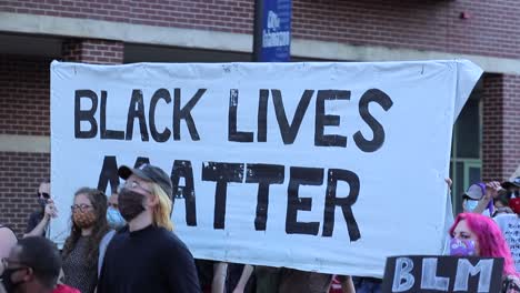 Dynamic-tracking-shot-of-large-Black-Lives-Matter-banner-at-protest
