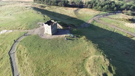 Historic-Rivington-tower-Lancashire-reservoir-countryside-aerial-birdseye-zoom-out-orbit-back-view