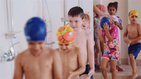 Children-Taking-A-Shower-Before-Going-Into-The-Swimming-Pool-For-Their-Swimming-Lesson---full-shot