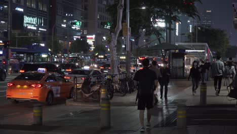 Crowd-Of-People-Walking-Outside-The-Gangnam-Station-In-Seoul,-South-Korea-At-Night---wide-shot