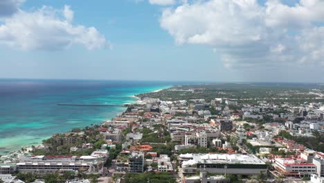 Caribbean-city-aerial-shot,-high-altitude-lateral-tracking-heading-inland