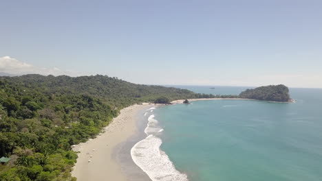 Aerial-drone-shot-of-Manuel-Antonio-beach-National-Park,-Costa-Rica-on-sunny-day