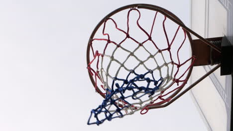 SLOW-MOTION-Man-Dunks-Ball-Into-Basketball-Ring,-CLOSE-UP