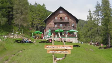 People-at-Dom-na-Peci,-popular-Alpine-mountain-hut,-Koroska,-Mt