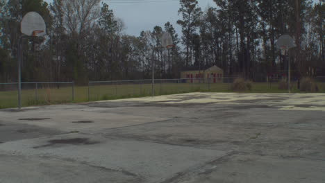 Empty-Rundown-Basketball-Court-Outside-on-Cloudy-Day,-Static-Wide