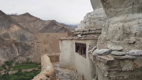 An-Old-Woman-walking-and-turning-the-Prayer-wheels-in-Lamayuru-Monastery