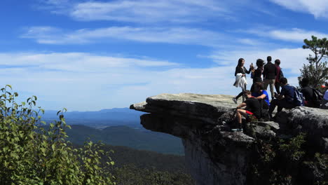 A-girl-posing-on-top-of-the-McAfee-Knob-while-friends-take-a-picture-of-her-and-her-friends