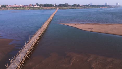 Natural-wooden-bamboo-bridge-stretching-over-the-river-Mekong-in-Kampong-Cham,-Cambodia