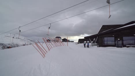 Ski-lift-and-people-outside-Hangurstoppen-restaurant,-still-shot---Voss-Norway