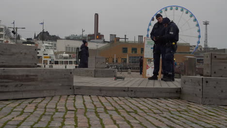 Policemen-looking-at-drone-controller-and-preparing-for-launch