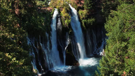 Looking-down-at-majestic-waterfalls-through-trees-at-Burney-Falls-California