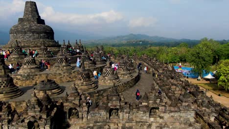 Crowd-of-tourists-on-top-terrace-of-ancient-Buddhist-temple-Borobudur,-Indonesia