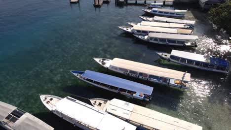 Aerial-tilt-up-shot-of-parking-boats-on-sea-shore