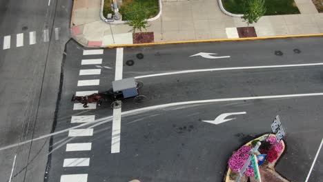 Amish-family-in-horse-and-buggy-carriage-navigates-busy-traffic-on-street