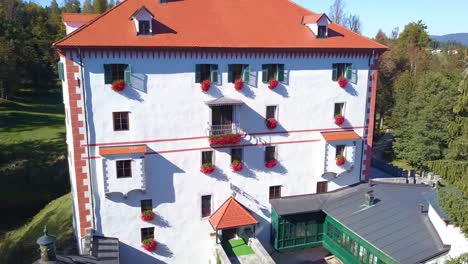 Renewed-Sneznik-Palace-in-Slovenia,-Aerial-View-of-Castle,-Tower-and-Bridge