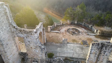 Epic-Aerial-Footage-of-Medieval-Castle-Ruins,-Sunrise-Sun-Flares