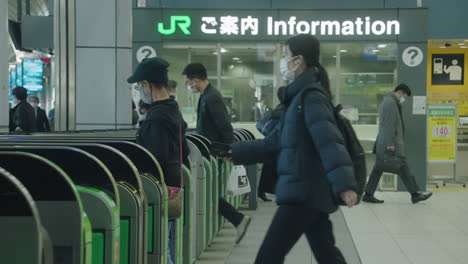 Passagiere-Und-Fahrkartenschalter-Am-Bahnhof-Shinagawa-Jr.-In-Tokio-–-Menschen,-Die-Während-Der-Pandemie-Masken-Tragen-–-Mittlere-Aufnahme,-Zeitlupe