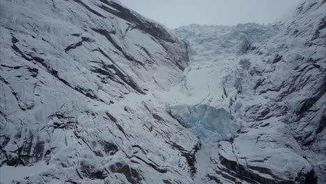 Flying-towards-blue-Briksdalsbre-glacier-in-Olden,-Norway,-Aerial-shot