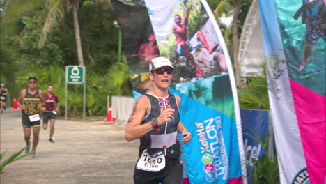 Slow-motion-of-a-female-triathlon-athlete-finishing-the-competition-running-concentrated-and-looking-exhausted