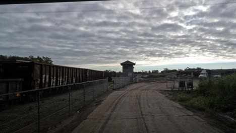 Driving-truck-going-underneath-a-bridge-towards-a-construction-site