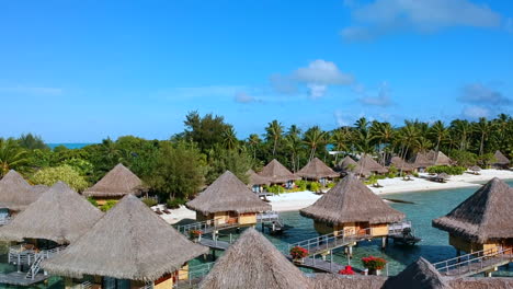 Raise-up-over-overwater-bungalows-to-show-the-turquoise-water-and-the-island-of-Bora-Bora,-French-Polynesia---Dolly-forward