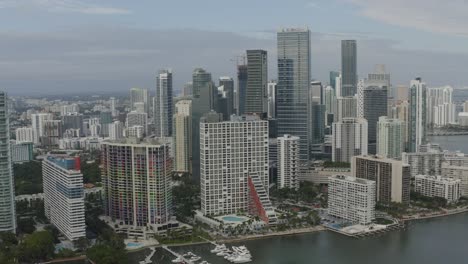 Aerial-semi-orbital-shot-in-downtown-Miami-showcasing-buildings-along-the-bayside