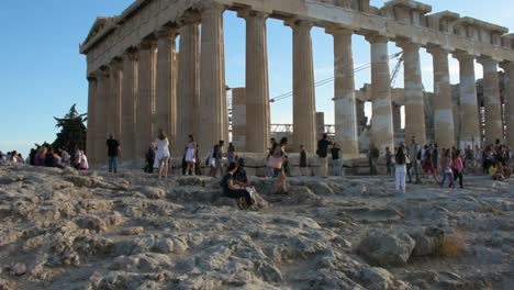 Tourists-enjoying-the-Parthenon-Temple-at-Acropolis-hill,-Athens,-Greece